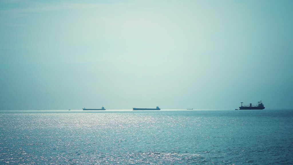 Container vessels crossing calm open water, representing global food trade